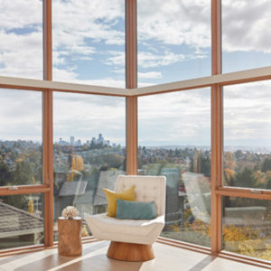 modern chair surrounded by windows with city view