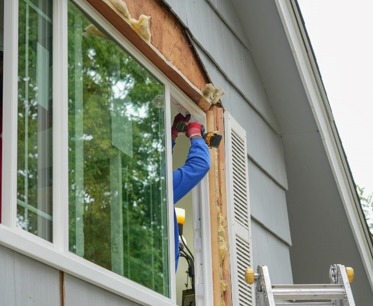 worker fixing vinyl window