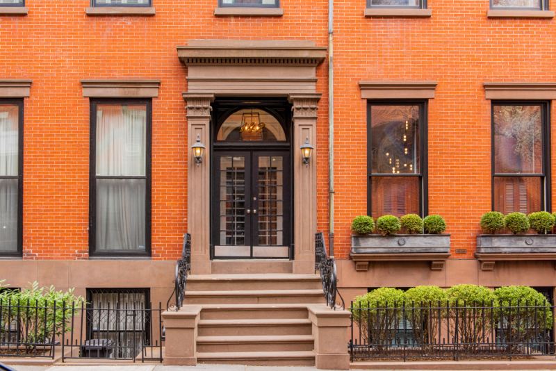 Traditional brick home with architectural windows and custom front entry doors