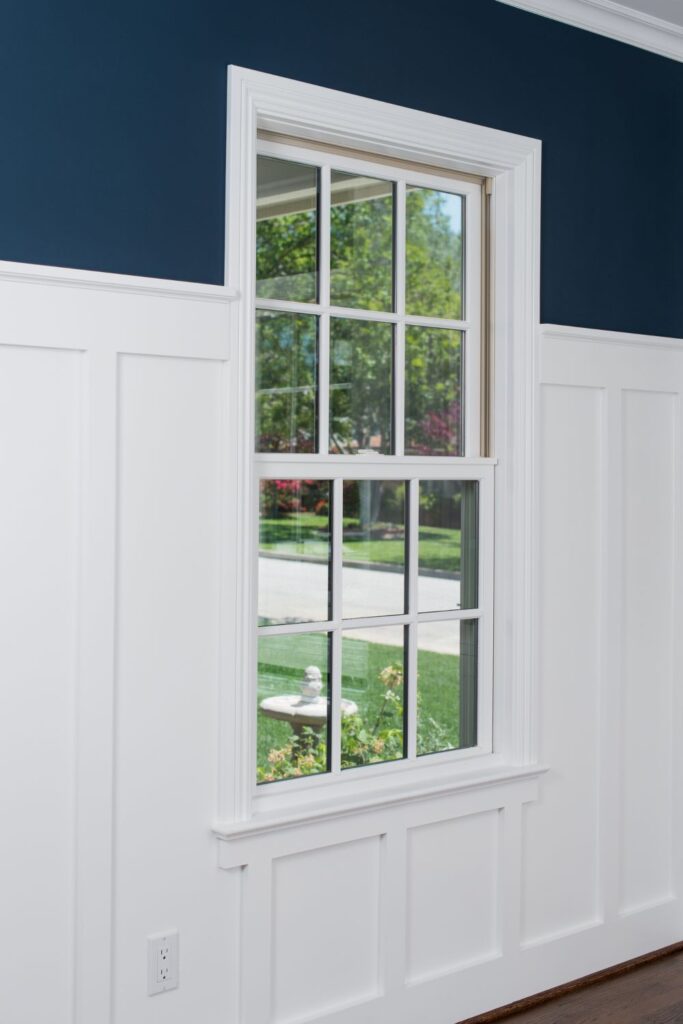 White double-hung window with divided grilles installed in a residential interior