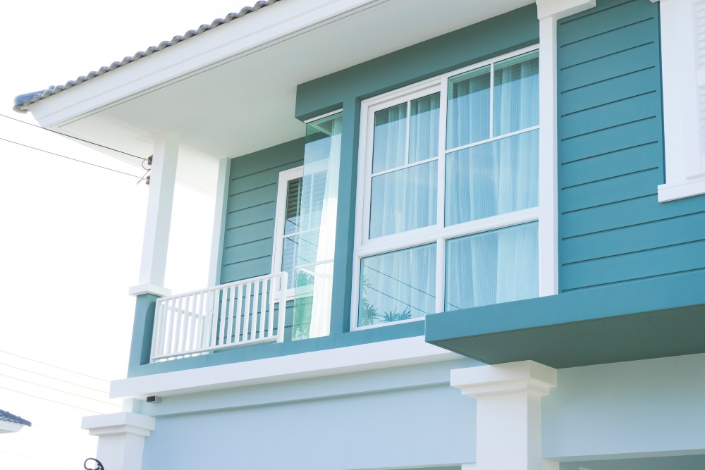 Modern home exterior featuring large energy-efficient replacement windows